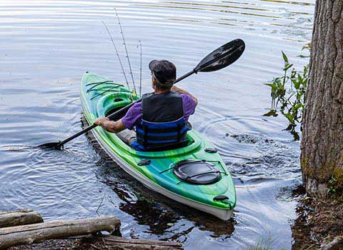 Man in canoe navigating a lake in Wisconsin